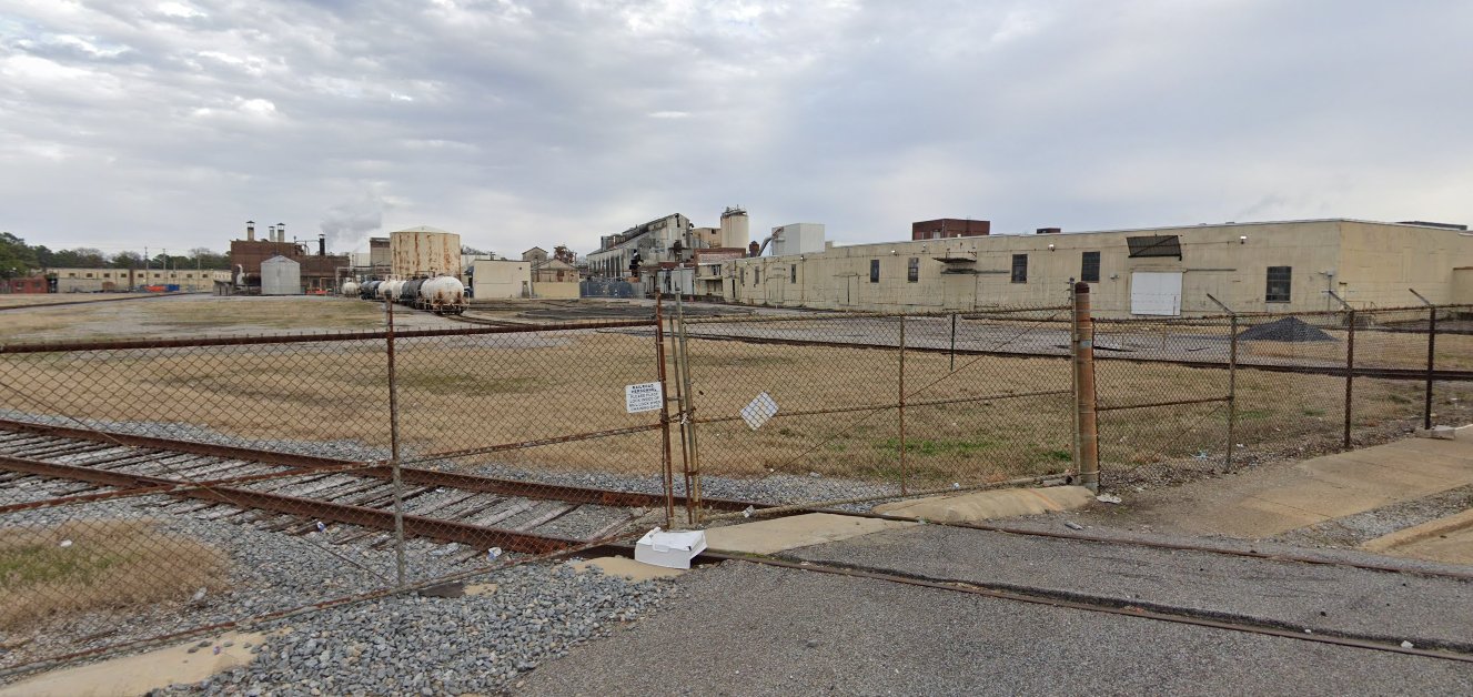 Memphis, TN site — rail siding with tank cars and warehouse buildings